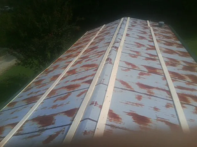 Rusted metal roof panels with new wood purlins before replacement — Storm Damage Roof Repair in Bullville by Roofing Brothers