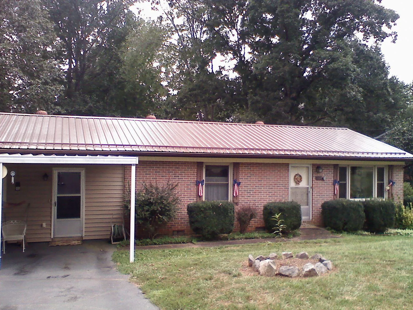 Bronze metal roof and carport on a brick ranch home — Roof Repair work by our crew in Bullville