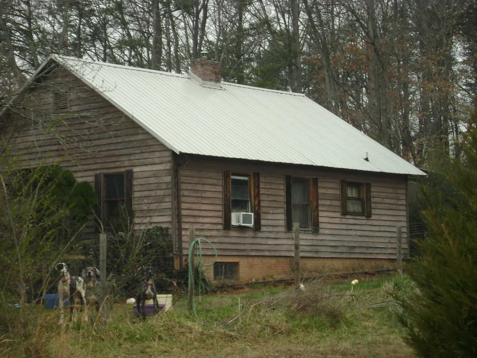 White metal roof on an old wood sided farmhouse, from a Metal Roof Installation job in Bullville